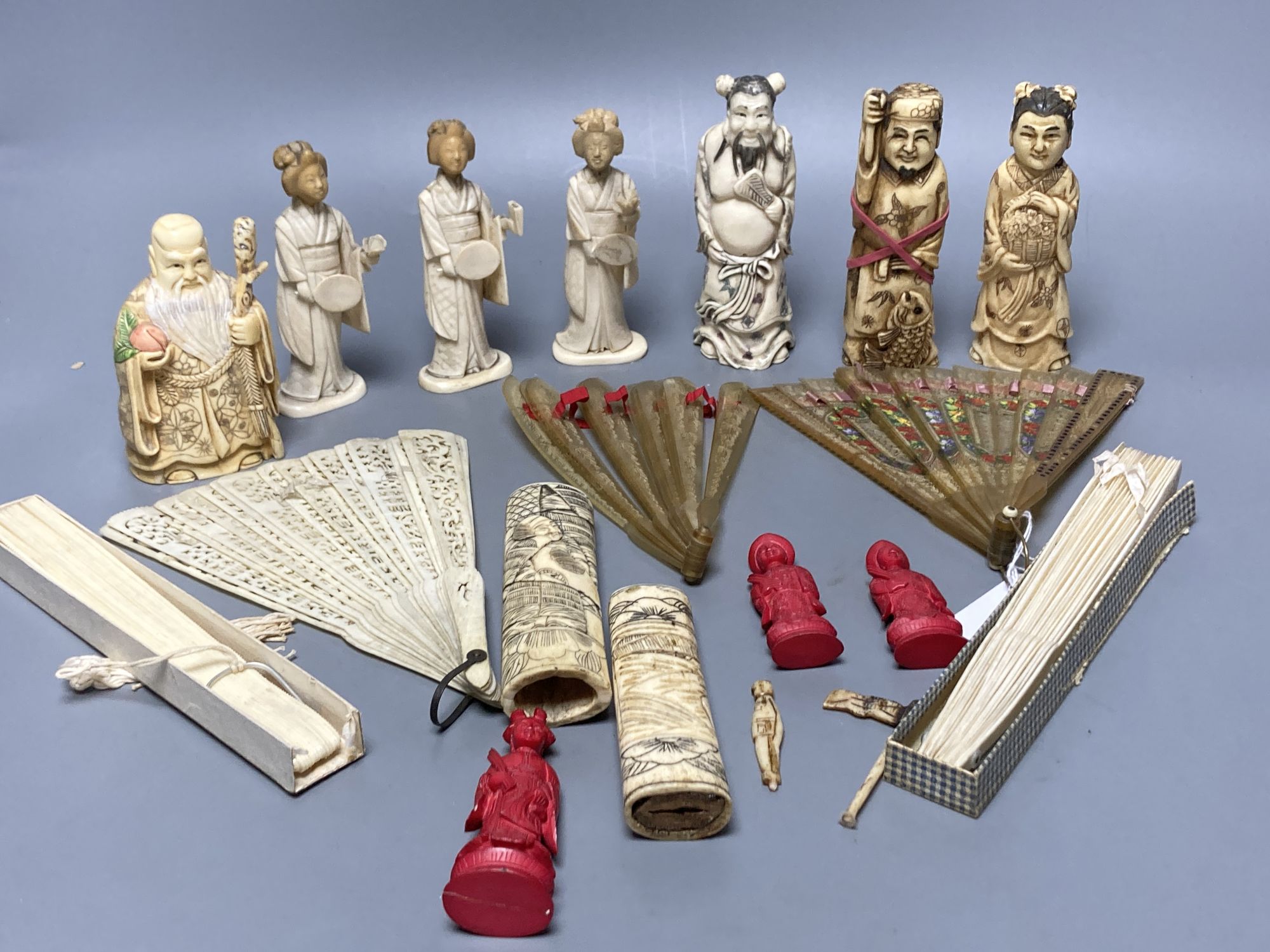 A quantity of bone and ivory carvings including fans and figures